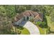Aerial view of a house with tile roof, driveway, and landscaping at 9291 Swaying Branch Rd, Sarasota, FL 34241