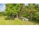 Relaxing picnic area with a white table under the shade of trees at 9291 Swaying Branch Rd, Sarasota, FL 34241