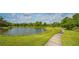 Peaceful walking trail alongside a tranquil lake at 9291 Swaying Branch Rd, Sarasota, FL 34241
