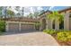 Tan house with three-car garage and paver driveway at 9291 Swaying Branch Rd, Sarasota, FL 34241