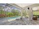 Screened-in pool and patio area with fire pit and lounge chairs at 9291 Swaying Branch Rd, Sarasota, FL 34241