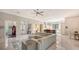 Open floor plan living room features a large sectional sofa and tile floors at 9291 Swaying Branch Rd, Sarasota, FL 34241