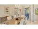 Elegant dining room with chandelier, hardwood floors, and views to the backyard at 9291 Swaying Branch Rd, Sarasota, FL 34241