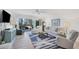 Light-filled living room featuring comfortable seating and hardwood floors at 2100 Benjamin Franklin Dr # 205, Sarasota, FL 34236