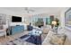 Relaxing living room with comfy seating and access to a balcony at 2100 Benjamin Franklin Dr # 205, Sarasota, FL 34236