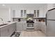 Updated kitchen featuring gray cabinets and stainless steel appliances at 2100 Benjamin Franklin Dr # 205, Sarasota, FL 34236