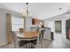 Dining area with round wooden table and chairs, view of kitchen at 4838 San Ortebello Dr, Bradenton, FL 34208