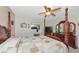 Spacious bedroom with a post bed, ceiling fan, dresser, and large window at 1511 Cloister Dr, Sun City Center, FL 33573