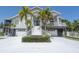 Two-story home with white siding and palm trees at 6317 Werner Ave, New Port Richey, FL 34652