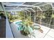 Enclosed pool and spa area with tropical landscaping at 6317 Werner Ave, New Port Richey, FL 34652