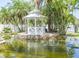 Serene backyard oasis featuring a gazebo and a charming pond with a fountain at 6317 Werner Ave, New Port Richey, FL 34652