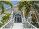 Front entry with stairs and tropical landscaping at 6317 Werner Ave, New Port Richey, FL 34652