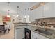 Eat-in kitchen with granite countertops and white cabinets at 4802 51St W St # 1010, Bradenton, FL 34210