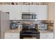 Modern kitchen features stainless steel appliances and granite countertops at 4802 51St W St # 1010, Bradenton, FL 34210