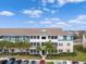 Two-story building with balconies and palm trees at 4802 51St W St # 1010, Bradenton, FL 34210