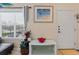 Bright entryway with a console table, red bowl, and beach-themed art at 4802 51St W St # 1010, Bradenton, FL 34210