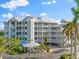 Aerial view of a three-story condo building with parking at 1240 Dolphin Bay Way # 301, Sarasota, FL 34242