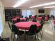 Clubhouse interior with round tables, chairs, and bookshelf at 1570 Pleasant Rd # J-26, Bradenton, FL 34207