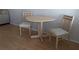Small round table with two chairs in a simple dining area at 1570 Pleasant Rd # J-26, Bradenton, FL 34207