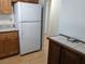 Kitchen features white appliances, wood cabinets, and light countertops at 1570 Pleasant Rd # J-26, Bradenton, FL 34207