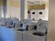 Shared laundry room equipped with multiple washers and dryers at 1570 Pleasant Rd # J-26, Bradenton, FL 34207