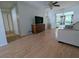 Living room with couch, TV, and sliding glass doors leading to the balcony at 1570 Pleasant Rd # J-26, Bradenton, FL 34207