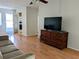 Living area featuring a couch, a TV, and access to the kitchen at 1570 Pleasant Rd # J-26, Bradenton, FL 34207