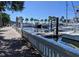 Scenic walkway along a marina with docked boats and palm trees at 1570 Pleasant Rd # J-26, Bradenton, FL 34207