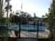 Community pool surrounded by a black metal fence and lush greenery at 1570 Pleasant Rd # J-26, Bradenton, FL 34207