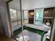 Sunroom with sliding doors, multiple windows, artificial turf flooring, and table and chairs at 1570 Pleasant Rd # J-26, Bradenton, FL 34207