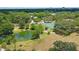 Aerial view of park featuring pond, tennis court, and lush green space at 1762 10Th St, Sarasota, FL 34236