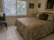 Bedroom with king-size bed, window and tiled floors at 1833 Sunny Dr # E-33, Bradenton, FL 34207