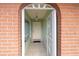 Front entry with brick archway and security door at 21024 Baffin Ave, Port Charlotte, FL 33954