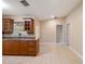 Kitchen features wood cabinets, granite countertops and access to other rooms at 21024 Baffin Ave, Port Charlotte, FL 33954