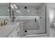 Modern bathroom features a glass shower with dual shower heads, marble accents, and updated fixtures at 2303 89Th Nw St, Bradenton, FL 34209