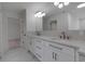Elegant bathroom with dual sinks, white marble countertops, stylish lighting and bronze fixtures at 2303 89Th Nw St, Bradenton, FL 34209