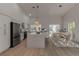 Bright, open kitchen featuring white cabinets, stainless steel appliances, and large center island at 2303 89Th Nw St, Bradenton, FL 34209