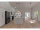 Bright, open kitchen featuring white cabinets, stainless steel appliances, and large center island at 2303 89Th Nw St, Bradenton, FL 34209