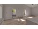 Bright living room with hardwood floors and natural light, featuring two large windows at 2303 89Th Nw St, Bradenton, FL 34209