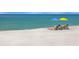 Relaxing beach scene with two lounge chairs and umbrellas at 3070 Grand Bay Blvd # 632, Longboat Key, FL 34228