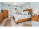 Spacious bedroom with calming blue walls and wooden furniture at 3070 Grand Bay Blvd # 632, Longboat Key, FL 34228