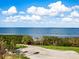 Scenic view of golf course with water and palm trees at 3070 Grand Bay Blvd # 632, Longboat Key, FL 34228
