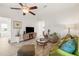 Living room with green sofa, wood-look floors, and ceiling fan at 3402 36Th W St, Bradenton, FL 34205