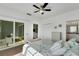 Bright bedroom with sliding glass doors to a patio, and a view of the bathroom at 3919 Cape Haze Dr # 506, Rotonda West, FL 33947