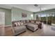 Spacious living room with a sectional sofa and access to a balcony at 3919 Cape Haze Dr # 506, Rotonda West, FL 33947
