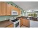 Modern kitchen featuring white appliances and light wood cabinets at 3919 Cape Haze Dr # 506, Rotonda West, FL 33947