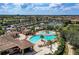 Expansive aerial view of the community pool area with tennis courts, poolside lounging, and ample parking at 6547 Willowshire Way, Bradenton, FL 34212