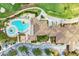 Bird's eye view of the community's clubhouse with a uniquely shaped pool, golf course, and ample parking at 6547 Willowshire Way, Bradenton, FL 34212