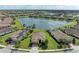Stunning aerial view of a lakeside community with well-maintained lawns and beautiful tile-roofed homes at 6547 Willowshire Way, Bradenton, FL 34212