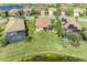 Aerial view of single Gathering homes with tile roofs, screened in pools, and lush tropical landscaping at 6547 Willowshire Way, Bradenton, FL 34212